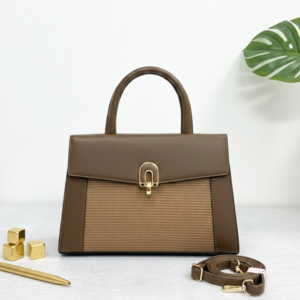 Elegant brown leather handbag with gold accents on modern desk - Mustard