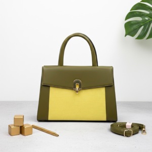 Elegant brown leather handbag with gold accents on modern desk - Forest